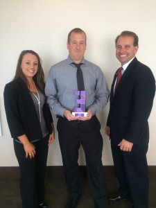 Empower employment counselors, Jennifer Burns (left) and Mike Marra (right) present Robert Gordon (middle), C&W Services District Manager, with the Employer of the Year award in October